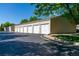 Exterior shot of row of detached garages with white doors and unit numbers at 930 Button Rock Dr # 28, Longmont, CO 80504
