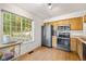 Well-lit kitchen featuring hardwood floors, stainless steel appliances, and a large window at 930 Button Rock Dr # 28, Longmont, CO 80504