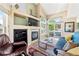 Cozy living room features a fireplace, a large window, and access to an outdoor patio at 930 Button Rock Dr # 28, Longmont, CO 80504
