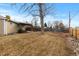 Large backyard with a covered patio and mature tree at 6963 S Albion St, Centennial, CO 80122