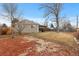 Large backyard with a covered patio and mature trees at 6963 S Albion St, Centennial, CO 80122