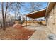 Covered patio and spacious backyard with woodchip groundcover at 6963 S Albion St, Centennial, CO 80122