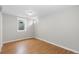 Finished basement bedroom with wood floors and large window at 6963 S Albion St, Centennial, CO 80122