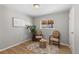 Bright bedroom with hardwood floors and two comfy chairs at 6963 S Albion St, Centennial, CO 80122