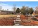 Ranch style home with landscaped yard and walkway at 6963 S Albion St, Centennial, CO 80122