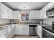 Modern kitchen with stainless steel appliances and granite countertops at 6963 S Albion St, Centennial, CO 80122