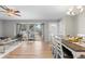 Living room with large windows, dining area, and hardwood floors at 6963 S Albion St, Centennial, CO 80122