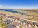 Aerial view of a neighborhood near a lake and open space, showcasing community living at 6450 S Riverwood Ct, Aurora, CO 80016