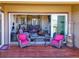 Deck area with comfortable seating and views through large sliding glass doors at 6450 S Riverwood Ct, Aurora, CO 80016