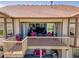 Outdoor deck with a grill, red seating, and sliding glass doors at 6450 S Riverwood Ct, Aurora, CO 80016