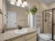 Well-lit bathroom features granite counters, tile floors, and a glass-enclosed shower at 6450 S Riverwood Ct, Aurora, CO 80016