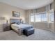 Bright bedroom with a large window providing ample natural light and scenic views at 6450 S Riverwood Ct, Aurora, CO 80016