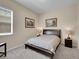 Cozy bedroom with neutral walls, carpet, and two side tables with lamps at 6450 S Riverwood Ct, Aurora, CO 80016
