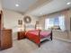 Inviting bedroom features a plush bed, large window, and carpeted floors at 6450 S Riverwood Ct, Aurora, CO 80016