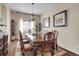 Cozy dining room with beautiful hardwood floors, a decorative chandelier and adjacent to the living area at 6450 S Riverwood Ct, Aurora, CO 80016