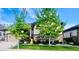 Charming home exterior with well-manicured lawn and mature trees in front yard at 6450 S Riverwood Ct, Aurora, CO 80016
