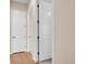 Neutral hallway features a mix of hardwood and carpeted floors with a white door and trim at 6450 S Riverwood Ct, Aurora, CO 80016