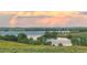 Scenic view of a peaceful lake surrounded by lush greenery under a picturesque, cloudy sky at 6450 S Riverwood Ct, Aurora, CO 80016