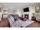 Spacious living room features a fireplace, hardwood floors, and stylish, comfortable furnishings at 6450 S Riverwood Ct, Aurora, CO 80016