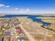Aerial image showcasing a lovely neighborhood with a lake view and walking paths at 6450 S Riverwood Ct, Aurora, CO 80016