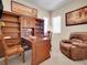 Inviting home office with custom wood built-ins, desk, and leather chair at 6450 S Riverwood Ct, Aurora, CO 80016