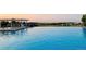 A view of a pool with a tranquil lake backdrop, perfect for relaxation and enjoyment at 6450 S Riverwood Ct, Aurora, CO 80016