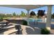 Community pool with a pergola, lounge chairs and hanging baskets offers a relaxing outdoor space at 6450 S Riverwood Ct, Aurora, CO 80016
