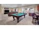Well lit game room featuring a pool table, couch and bar seating at 6450 S Riverwood Ct, Aurora, CO 80016