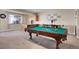 Entertaining game room with a pool table, and wet bar with seating area at 6450 S Riverwood Ct, Aurora, CO 80016