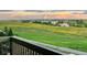 Picturesque scenic view of open fields, lake and a cloudy sky from the deck at 6450 S Riverwood Ct, Aurora, CO 80016