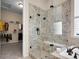 Modern bathroom featuring a glass enclosed shower, seat, and walk in closet at 6450 S Riverwood Ct, Aurora, CO 80016