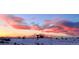 Stunning sunset view over a snow-covered landscape, creating a vivid and colorful sky at 6450 S Riverwood Ct, Aurora, CO 80016