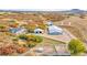 Stunning aerial perspective of the property with multiple barns, horse runs, and surrounding natural beauty at 810 N Perry Park Rd, Sedalia, CO 80135