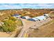 Scenic aerial view of a horse property featuring multiple outbuildings, horse runs and a main house at 810 N Perry Park Rd, Sedalia, CO 80135
