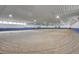 Large indoor horse riding arena with sand floor and bright lighting at 810 N Perry Park Rd, Sedalia, CO 80135