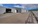 Exterior view of a barn with a gray metal facade and a gravel driveway at 810 N Perry Park Rd, Sedalia, CO 80135