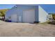 Spacious metal barn building with multiple doors, offering ample storage or workspace at 810 N Perry Park Rd, Sedalia, CO 80135