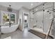Bright bathroom showcasing a soaking tub and glass enclosed shower with a bench at 810 N Perry Park Rd, Sedalia, CO 80135