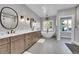Bright bathroom featuring double vanity, undermount sinks, and soaking tub with chandelier at 810 N Perry Park Rd, Sedalia, CO 80135