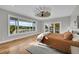 Bright bedroom features a large window with scenic views, fan, and patio access at 810 N Perry Park Rd, Sedalia, CO 80135