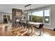 Stylish dining area featuring a stone fireplace, modern lighting and expansive windows with scenic views at 810 N Perry Park Rd, Sedalia, CO 80135