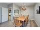 Rustic dining room featuring wooden table, chairs and chandelier at 810 N Perry Park Rd, Sedalia, CO 80135
