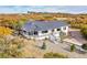 Charming white home with a covered porch, multiple entryways, and manicured landscaping at 810 N Perry Park Rd, Sedalia, CO 80135