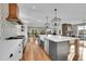 Open-concept kitchen with a large island, stainless steel appliances, and a view into the living room at 810 N Perry Park Rd, Sedalia, CO 80135