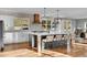 Modern kitchen with a large island, pendant lighting and white cabinets, perfect for cooking and entertaining at 810 N Perry Park Rd, Sedalia, CO 80135