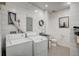 Bright laundry room with shiplap walls, washer, dryer, utility sink, and rustic decor at 810 N Perry Park Rd, Sedalia, CO 80135