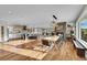 Open-concept kitchen and dining area with modern lighting, fireplace and hardwood flooring at 810 N Perry Park Rd, Sedalia, CO 80135
