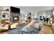 Open living space with a stone fireplace, modern furnishings, and seamless kitchen access at 810 N Perry Park Rd, Sedalia, CO 80135