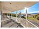Enjoy scenic views from this covered porch with white railing, offering a serene outdoor living space at 810 N Perry Park Rd, Sedalia, CO 80135