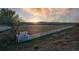Well-maintained horse riding arena featuring sturdy white fencing, scenic views, and water truck at 810 N Perry Park Rd, Sedalia, CO 80135
